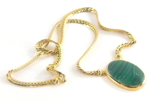 A malachite pendant and chain, the oval malachite in rub over setting, 3cm x 2cm, on an Italian style articulated neck chain, with heavy link clasp, marked 375, 46cm long overall, 26.2g all in.