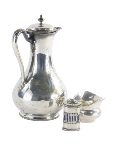 A late 19th/early 20thC helmet shaped silver cream jug, with a decorative handle, hallmarks rubbed, 2oz, and a George V silver pepper pot with a pierced body and blue glass liner, Chester 1927, 1oz, without liner, and a silver plated hot water jug. (3)