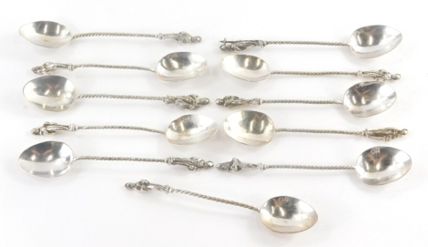 A collection of continental white metal apostle spoons, with twisted handles terminating in various apostle figures, the bowls with various markings, 5½oz.