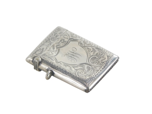 An Edward VII silver Vesta case, decorated with scrolls and a shield shaped cartouche with the initials JW, Birmingham 1909, 5cm high.