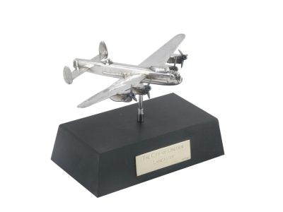 An Elizabeth II silver model of a Lancaster Bomber, on a plinth base, the plaque stating The City of Lincoln Lancaster, limited edition 49/250, Birmingham 1988, 4¾oz, the plane 10cm x 15cm, on the base 9cm high.