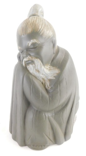 A Lladro matte glazed porcelain figure of a seated oriental gentleman, 17cm high.