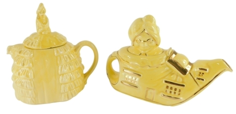 A Lingard pottery teapot, modelled in the form of The Old Lady That Lived In A Shoe, with a yellow glaze, and a yellow glazed novelty teapot, modelled in the form of a lady with a crinoline dress. (2)