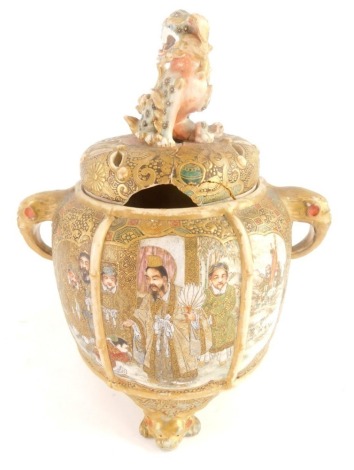 A late 19th/early 20thC Japanese earthenware pot pourri vase, with a dog of fo finial, the base decorated with figures in Satsuma style, within gilt borders, 22cm high. (AF)