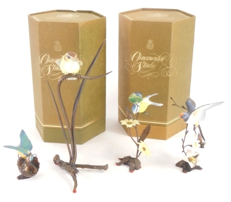 A collection of four Royal Worcester porcelain ornamental studio figures of birds, to include Swallow, Blue Tit, etc., each standing on a bronze effect metal base.