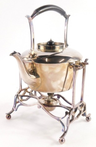 A late 19th/early 20thC silver plated spirit kettle, on stand with ebonised handle burner on shaped support, 30cm high.