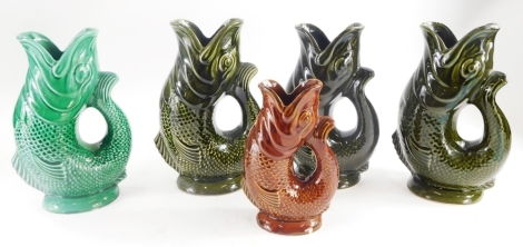 A collection of Dartmouth fish shaped pottery glug vases, in various coloured glazes, the largest 23cm high. (5)