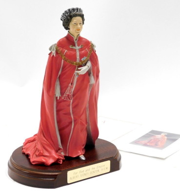 A cold cast porcelain figure of Queen Elizabeth II, sculpted by Timothy Potts, commissioned for holders and medallists of the OBE, limited edition number 484, on a hardwood base with brass plaque stating 'For God and the Empire, Albert Sidney Denton BEM,'