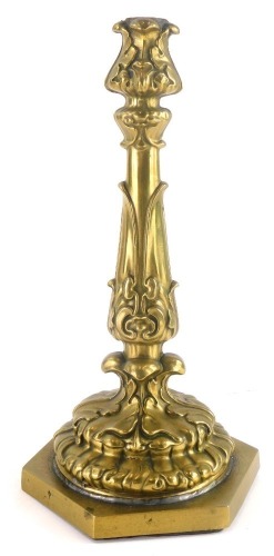 A late 19th/early 20thC gilt brass candlestick, decorated with leaves, drilled for electricity, 31cm high. (AF)