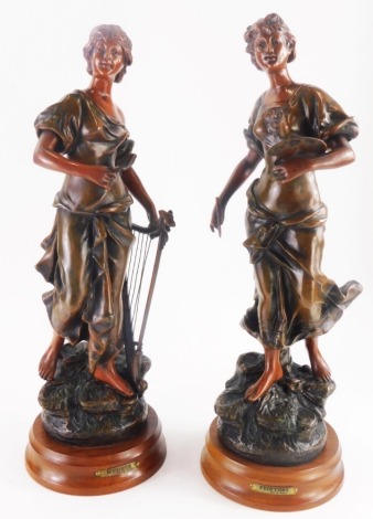 A pair of late 19th/early 20thC bronzed spelter figures, titled 'Musique and Peinture', each on a hardwood base, 47cm high.