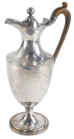 A 19thC silver plated urn shaped claret jug, with carved wooden handle on a domed foot, unmarked, 32cm high.