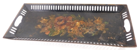 A late 19th/early 20thC tole peint rectangular tray, with pierced borders decorated centrally with flowers on a black ground, 55cm wide.