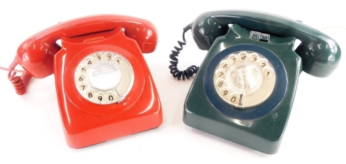 Two vintage GPO dial telephones, in red and green.