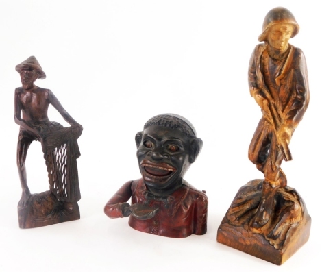 An African carved treen figure of a gentleman, a carved treen figure of a French game keeper, and a cast metal money bank. (3)