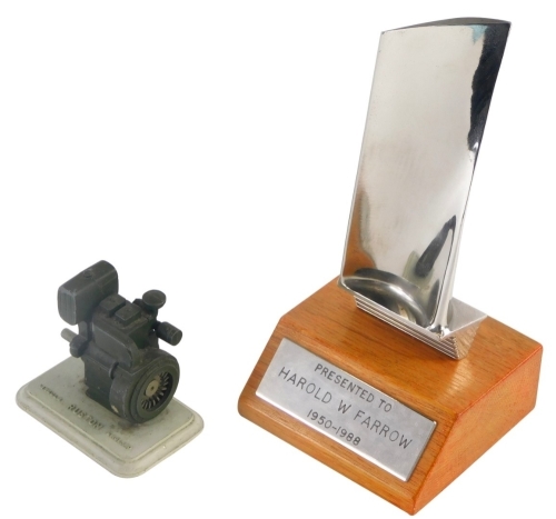 A miniature cast metal Ruston Lincoln machine gun, on base, 7cm high, and a trophy presented to Harold W Farrow 1950-1988, on a treen base.