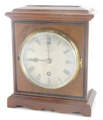 An early 20thC mahogany cased mantel clock, the metal dial with Roman numeric dial, the case decorated with a beaded border, for Hamilton and Inches Edinburgh, 20cm high, 14cm wide, 7cm deep.