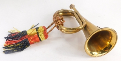 A Royal Artillery brass bugle, with rope tassels and Ubigue crest cast to front, 28cm long. - 2
