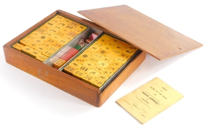 A mid 20thC Jackpot Mah Jong set, in an oak case.