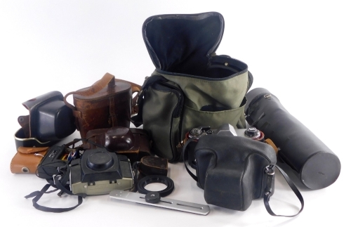 A collection of cameras, binoculars etc., to include a Kodak Brownie camera, a Prakica camera, binoculars in leather case, etc. (1 tray)