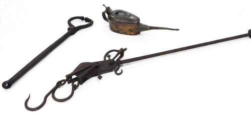 A collection of bygones, to include iron stillyard scales, a set of Blacksmiths tools, and an oil can.