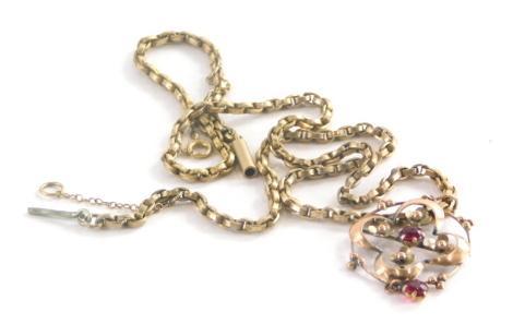 An Art Nouveau pendant, the circular pendant set with garnets in floral cluster, yellow metal stamped 9ct, 3.5cm high on a yellow metal coloured neck chain but unmarked with barrel clasp and safety chain, 44cm long, 10.7g all in.