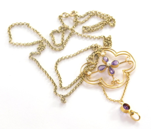 An Art Nouveau pendant and chain, the amethyst and seed pearl set cluster Art Nouveau pendant yellow metal unmarked, 5cm high on a fine link 9ct gold chain, 50cm long, 5.8g all in.