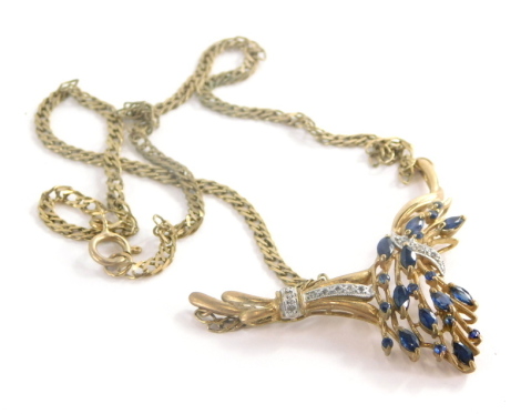 An Eastern style pendant and chain, the arched pendant set with oval cut sapphires, and tiny cz stones on a bracket chain, the pendant 5cm wide the chain 19cm long to each side, the chain only yellow metal stamped 9ct, 10.4g all in.