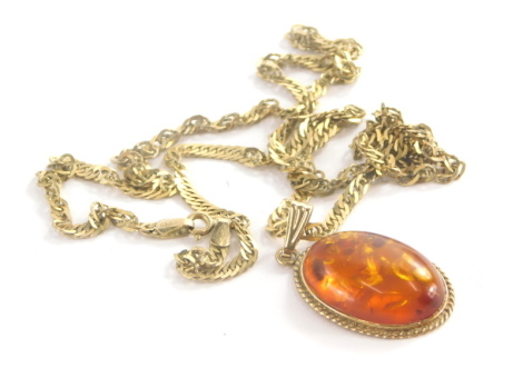 A 9ct gold imitation amber pendant and chain, the oval imitation amber in 9ct gold bordered pendant mount 4cm high, on a fancy link chain, yellow metal stamped 375, 60cm long, 12.3g all in.