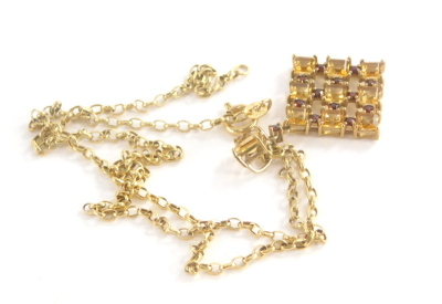 A 9ct gold pendant and chain, the citrine and garnet set cross design pendant, yellow metal marked 375, 4cm high on a belcher link chain marked 375, 43cm long, 4.7g all in.