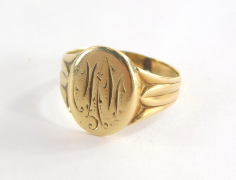 A gentleman's signet ring, with oval shield bearing the initials MN?, with three fanned design shoulders, yellow metal, marked to exterior with acorn leaf , ring size T, 3.6g all in.