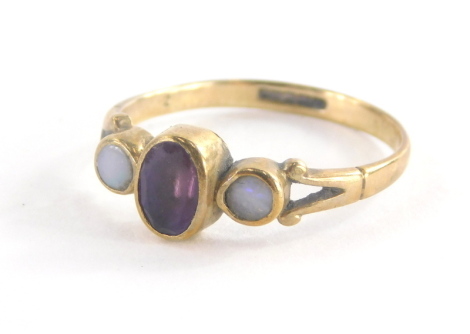 A 9ct gold dress ring, with central oval amethyst in rub over setting flanked by two opals on V splayed shoulders, ring size M, 1.5g all in, misshapen.