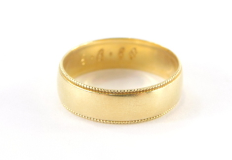 An 18ct gold wedding band, bearing number and date inscription R112-6 6.8.88, London 1886, with a ribbed design outer border, ring size P½, 3.7g.