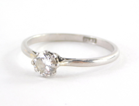 A diamond solitaire ring, with round brilliant cut diamond approx. 0.15ct in eight claw setting with pierced shoulders on a plain band white metal stamped platinum ring size M½, 2.1g all in.