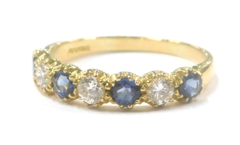 An 18ct gold sapphire and diamond dress ring, set with four round brilliant cut sapphires, each approx 0.10ct, broken by three round brilliant cut diamonds of similar size, in a claw setting, ring size W, 4g all in.