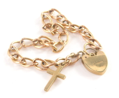 A 9ct gold charm bracelet, with curb link chain, additional crucifix pendant and a heart shaped padlock, the chain 18cm long, 9.3g.