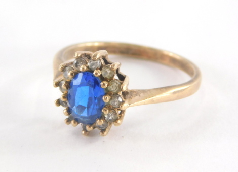 A 9ct gold floral cluster ring, set with central blue paste stone, surrounded by cz, each in claw setting, ring size O, 2.4g all in.