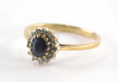 A 9ct gold cluster ring, set with central oval cut sapphire, surrounded by cz, in raised claw setting with pierced shank, ring size I, 1.6g all in.