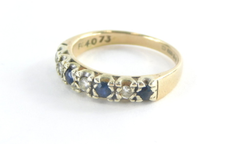 A 9ct gold half hoop eternity ring, set with four sapphires and three tiny diamonds, in a platinum setting, ring size L, 2.5g all in. (misshapen)