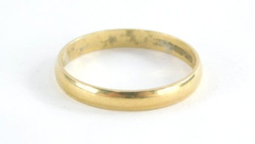 An 18ct gold wedding band, bearing the inscription lucky, Birmingham 1975, ring size Q½, 2.1g all in.