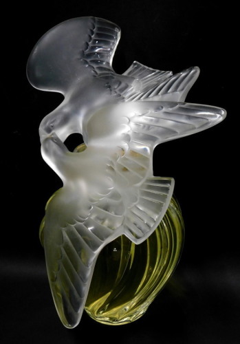 A Marc Lalique for Nina Ricci 'L'ai air du Temps' perfume bottle, the frosted glass stopper modelled in the form of two doves, the clear glass bottle containing liquid, etched mark to base, 31cm high.