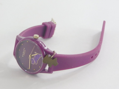 A Radley London ladies wristwatch, on purple plastic strap, with dial depicting Radley dog in glitter finish, in a silver cylindrical gift box and outer box. - 2