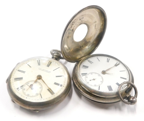 An early 20thC silver half hunter pocket watch, with blue enamel numerals, and a silver pocket watch, the dial stamped Swinburn Workington.