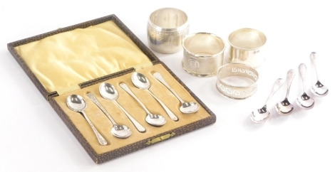 A collection of small silver, to include three silver napkin rings, one with engine turned decoration and R initial in a shaped cartouche, various silver spoons, etc., weighable silver 1½oz.