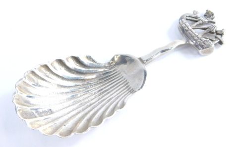 An early 20thC caddy spoon, with shell shaped bowl and boat handle, hallmarked with import marks, white metal, 8cm high, 0.4oz.