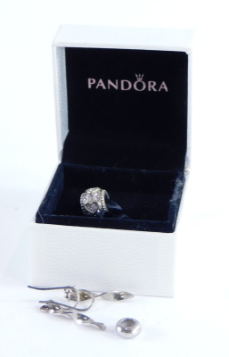 A group of Pandora and other jewellery, to include a Pandora silver breaker, a Pandora silver and pink stone set heart charm and a pair of silver drop earrings. (3)