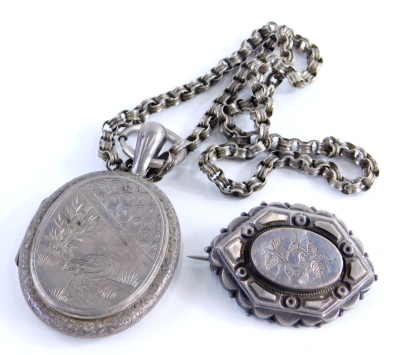 Two items of silver jewellery, to include a Victorian silver floral engraved brooch, a silver engraved stork locket pendant on a silver plated chain, 21.5g all in. (2)