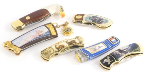 A collection of Franklin Mint hunting knives, each decorated in different styles to include an Eagle, etc.