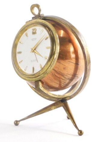 A mid 20thC copper and brass carriage clock, modelled in the form of a globe with revolving stand, the dial stamped Lancel Paris 8 Jours Reveil, 15cm high.