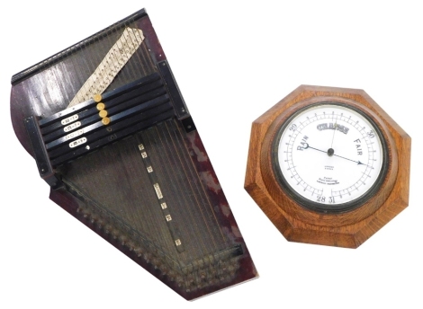 An aneroid barometer, in an oak case, stamped Lowdon, Dundee and a zither, (2)