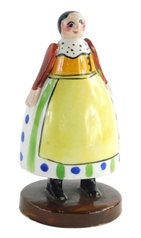 A Crown Staffordshire pottery Folk Art figure, with green stamp and impressed mark to under side, 13cm high.